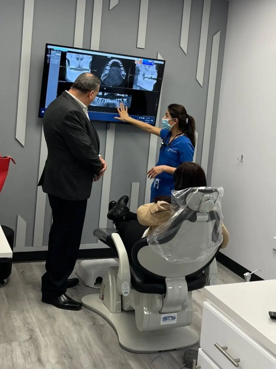 Dentist explaining X Ray to patient. Nashville Dentures and Implants.