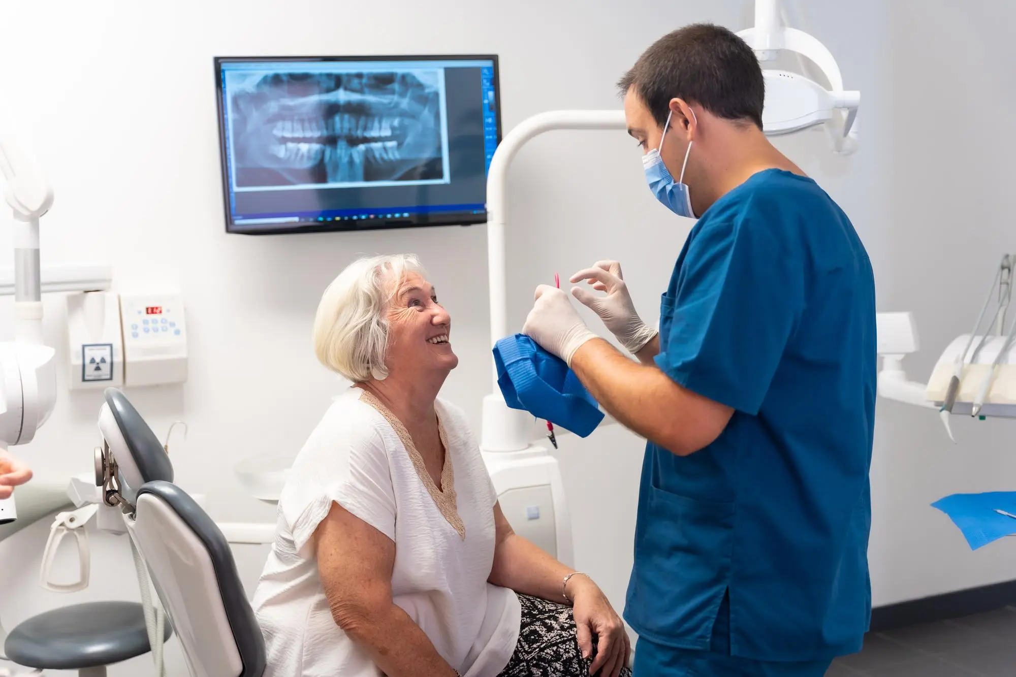 Dentist talking to patient. Nashville Dentures and Implants.