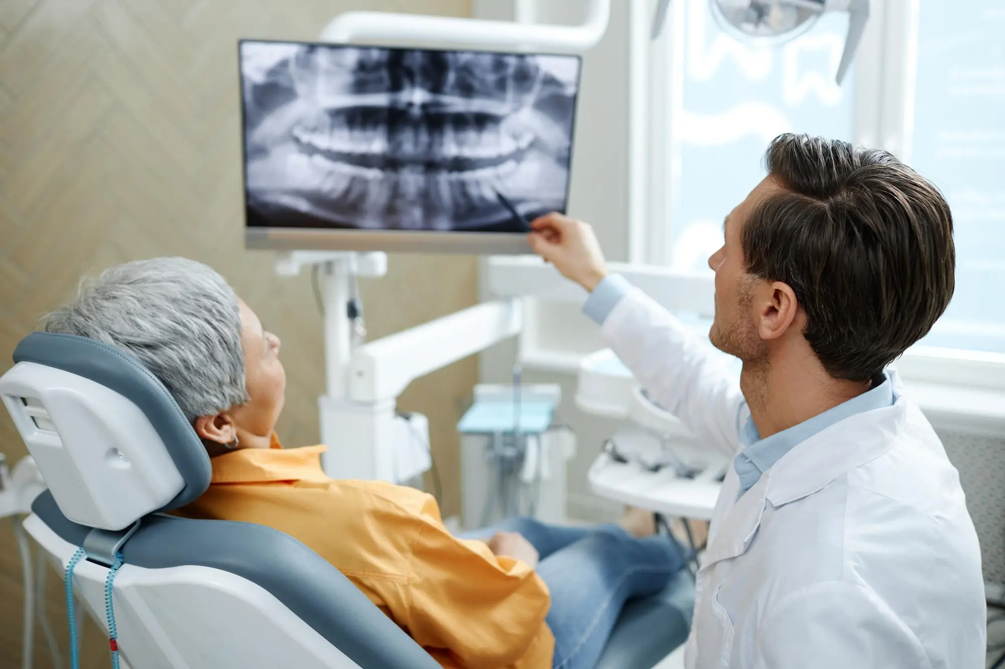 Dentist explaining X ray to a patient. Dental Implants.Nashville Dentures and Implants.