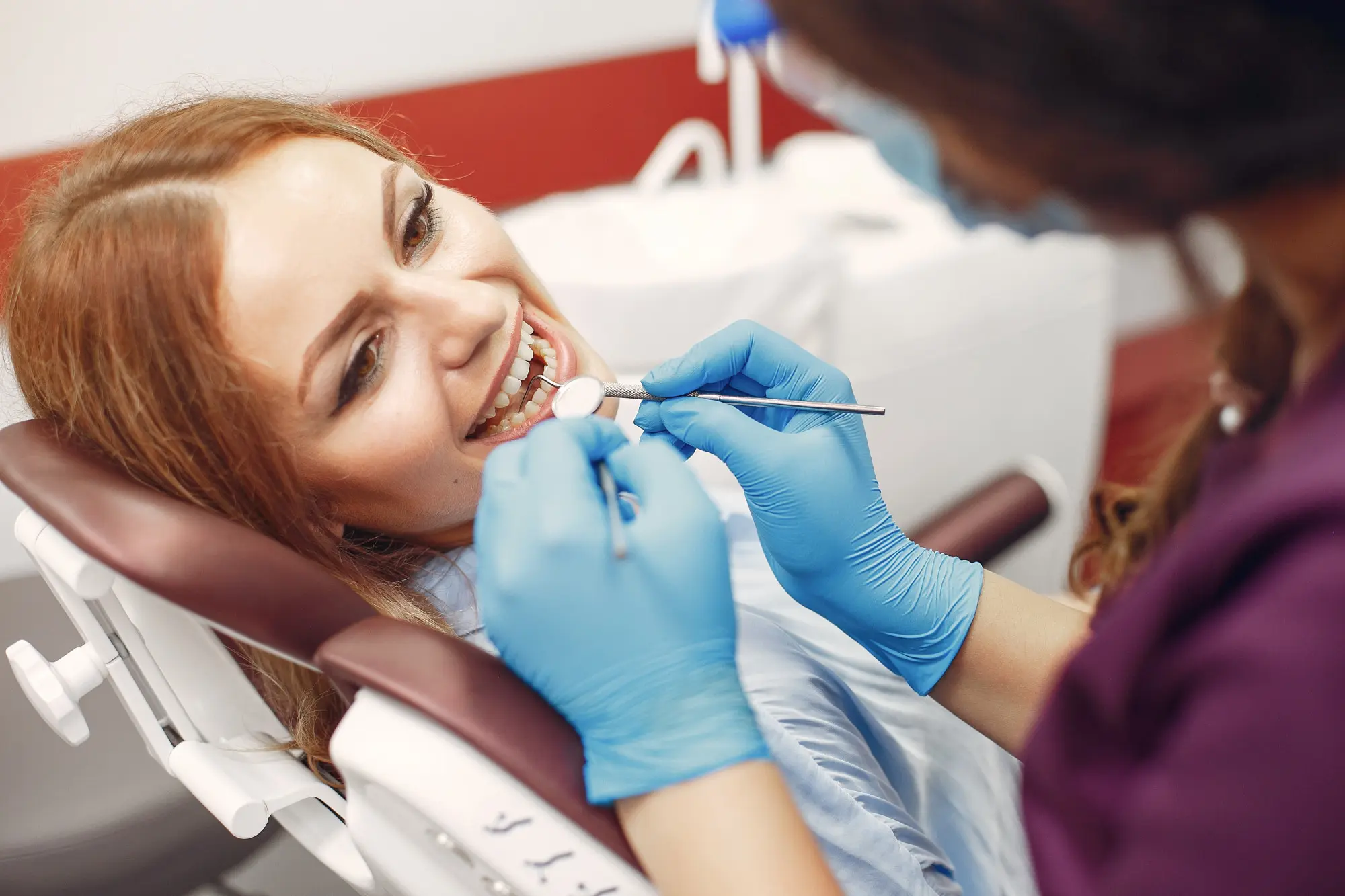Image of a dentist checking a lady. Nashville Dentures and Implants.